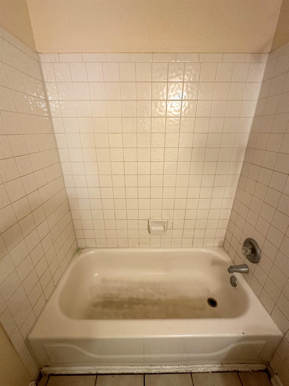 Before bathtub and tile refinishing with wall and tub discoloration