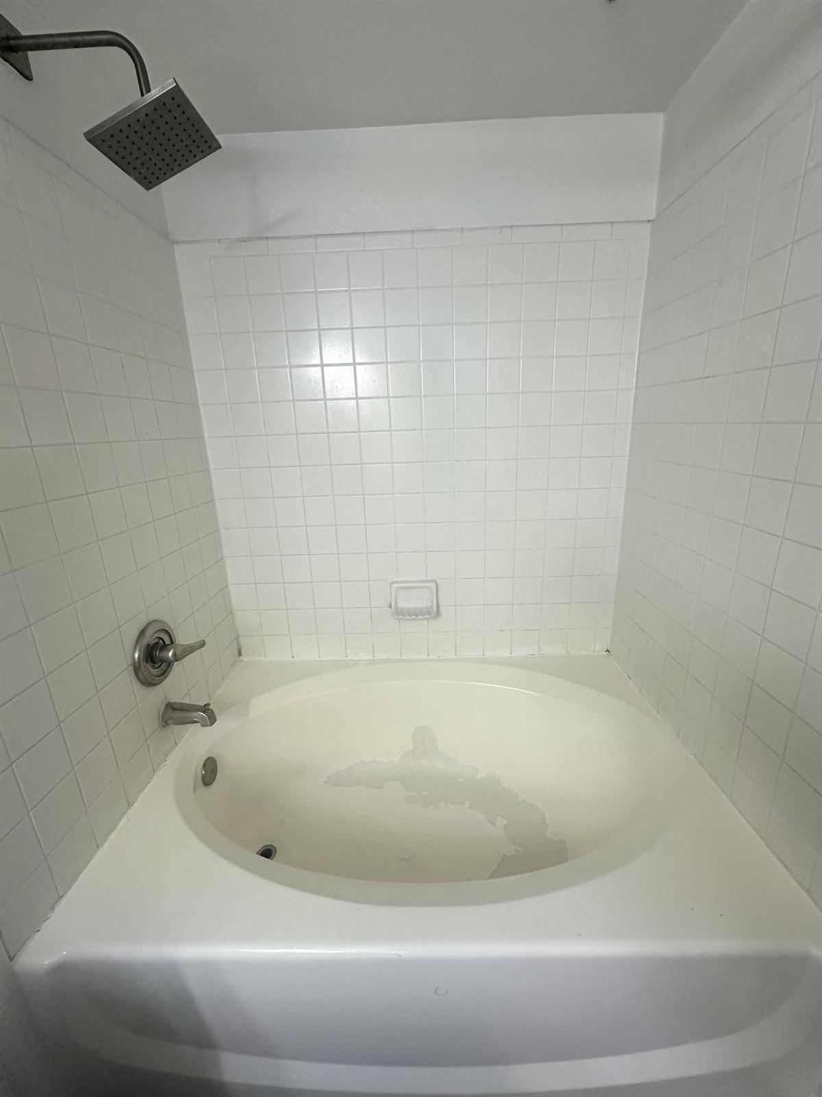 Before shower floor resurfacing with worn pan and damaged coating
